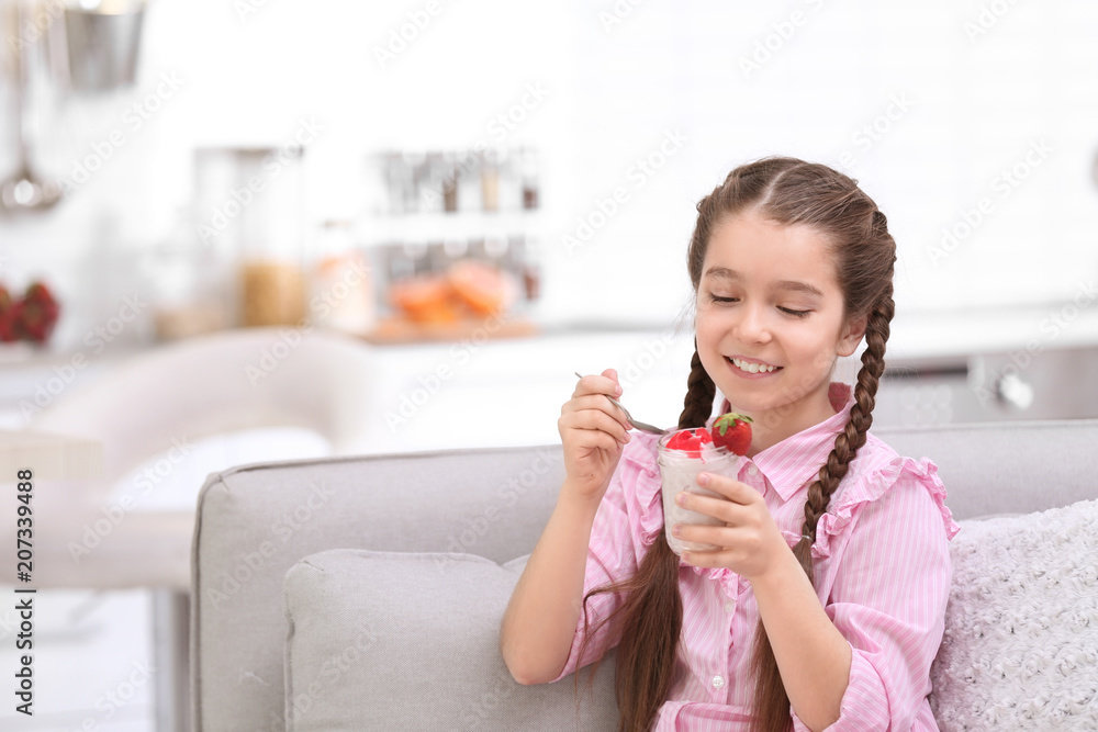 Cute girl eating tasty yogurt at home Cute girl eating tasty yogurt at home