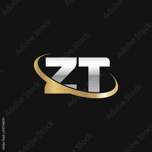 Initial letter ZT, overlapping swoosh ring logo, silver gold color on black background photo