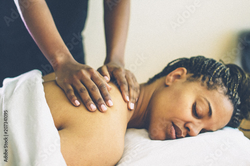 Woman receiving back massage at spa photo