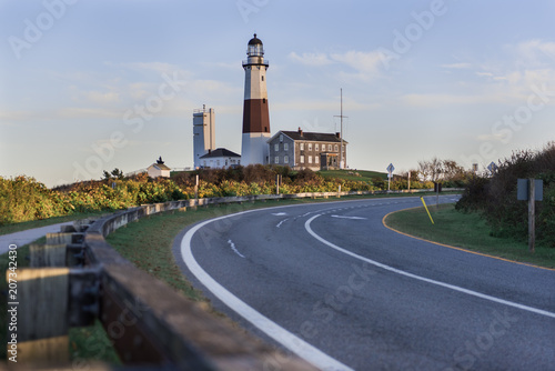 Street disappearing into background of Montauk Lighthouse on Long Island, New York during sunset.