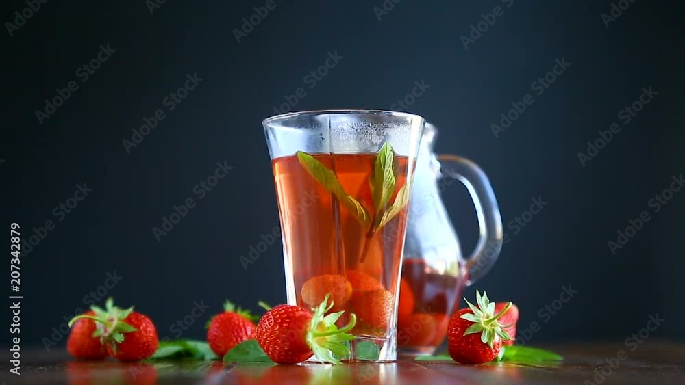 Sweet compote of ripe red strawberries in a glass decanter on a table Sweet compote of ripe red strawberries in a glass decanter on a table