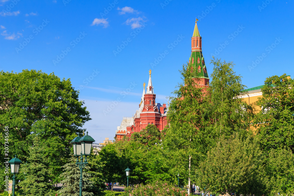 Tower of Moscow Kremlin and building of State Historical Museum against blue sky. View from Alexandrovsky Garden