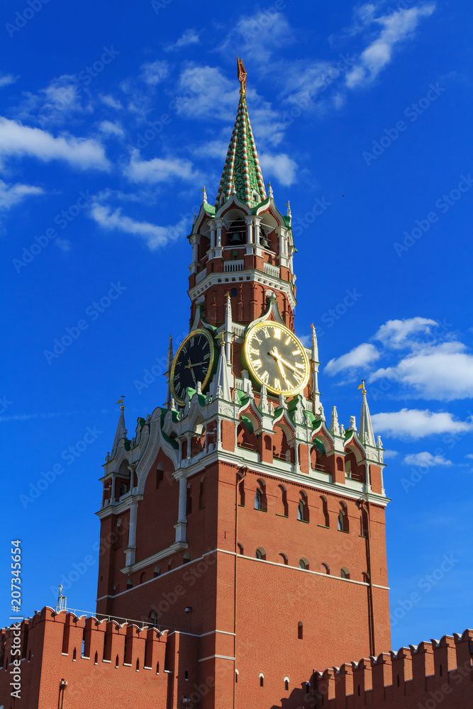 Spasskaya tower of Moscow Kremlin on a blue sky background in sunny evening