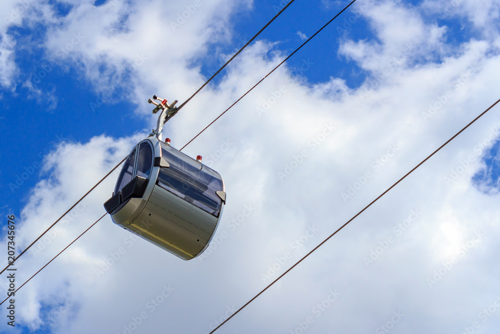 Cabin of the cable car closeup on a background of blue sky with clouds