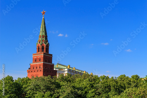 Moscow Kremlin tower with a red star on a blue sky background