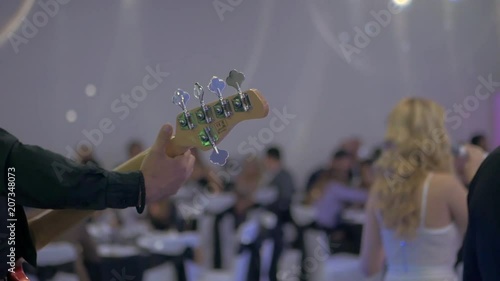 Bass player on wedding party indoor