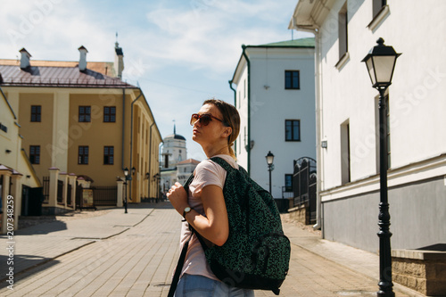 woman is looking at street buildings photo