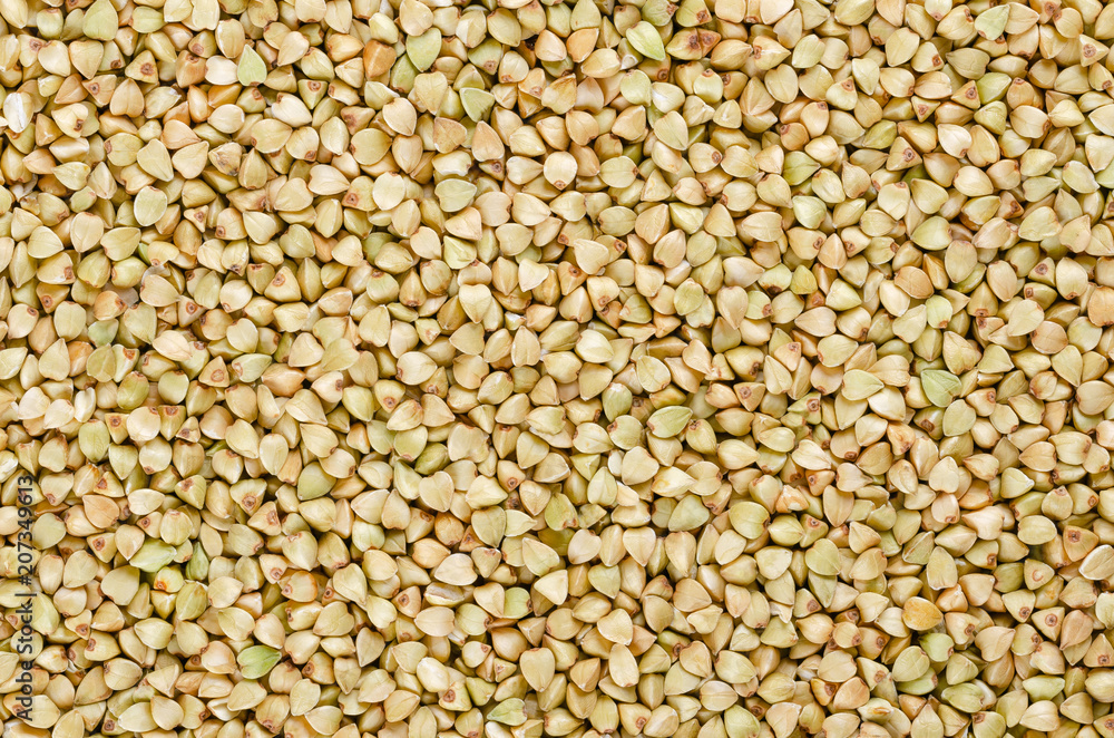 Hulled common buckwheat grains, surface from above. Gluten free pseudocereal. Fagopyrum esculentum, also known as Japanese or silverhull buckwheat. Dried seeds. Food photo, close up. Hulled common buckwheat grains, surface from above. Gluten free pseudocereal. Fagopyrum esculentum, also known as Japanese or silverhull buckwheat. Dried seeds. Food photo, close up.