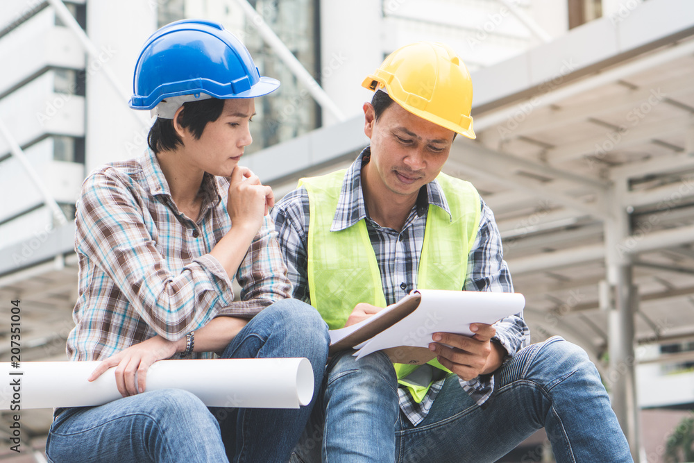 Construction builder teamwork work concept. Top view of engineer and architect planning work. male foreman pointing on blueprint explaining job to co worker in construction site. Construction builder teamwork work concept. Top view of engineer and architect planning work. male foreman pointing on blueprint explaining job to co worker in construction site.