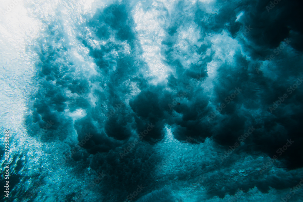 Barrel wave underwater. Blue ocean in underwater