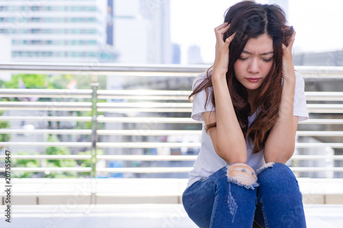 Stressed Sad Woman with Headache. Upset Woman holding her head in her hands