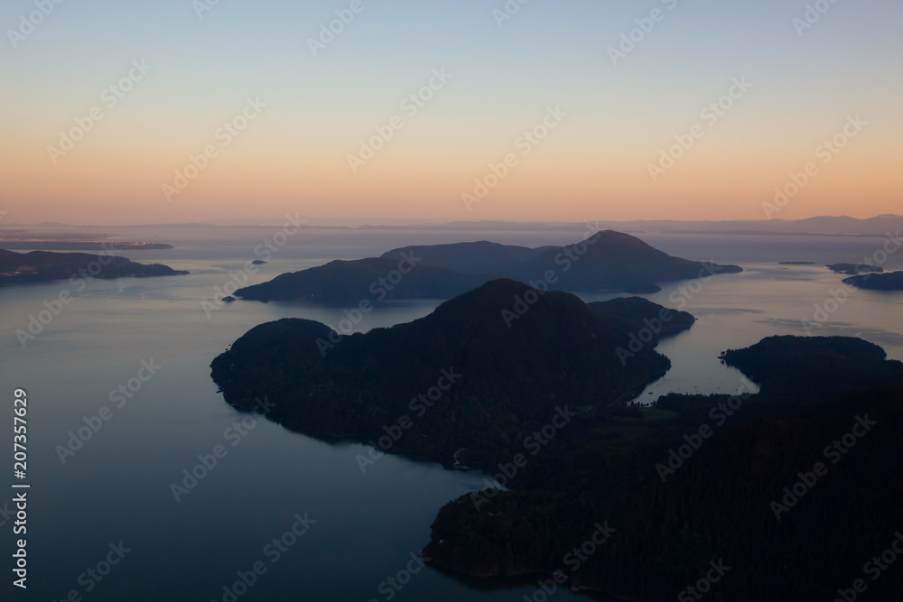 Fototapeta premium Aerial view of Howe Sound during a vibrant sunset. Taken North of Vancouver, British Columbia, Canada.