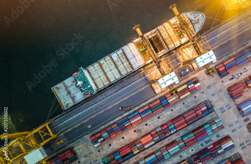 Logistics and transportation of Container Cargo ship and Cargo plane with working crane bridge in shipyard at sunrise, logistic import export and transport industry background