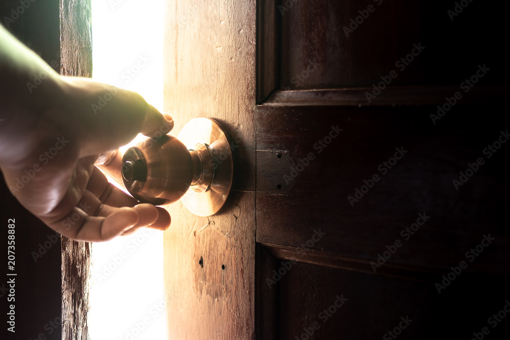 Fototapeta premium Use your hand to open the door to the light.