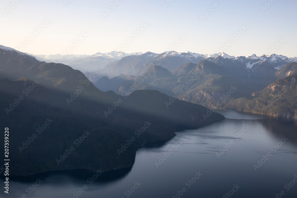 Striking Aerial View of the Canadian Mountain Landscape during a vibrant sunny day. Taken at Pitt Lake, North of Vancouver, British Columbia, Canada.