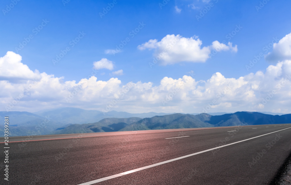 Fototapeta premium Road asphalt and mountain sky cloud background