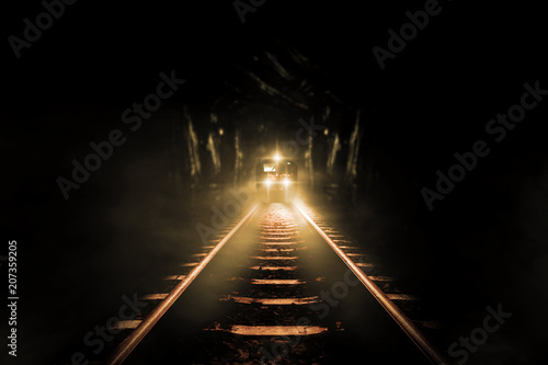 Old trains run through old tunnels at night.