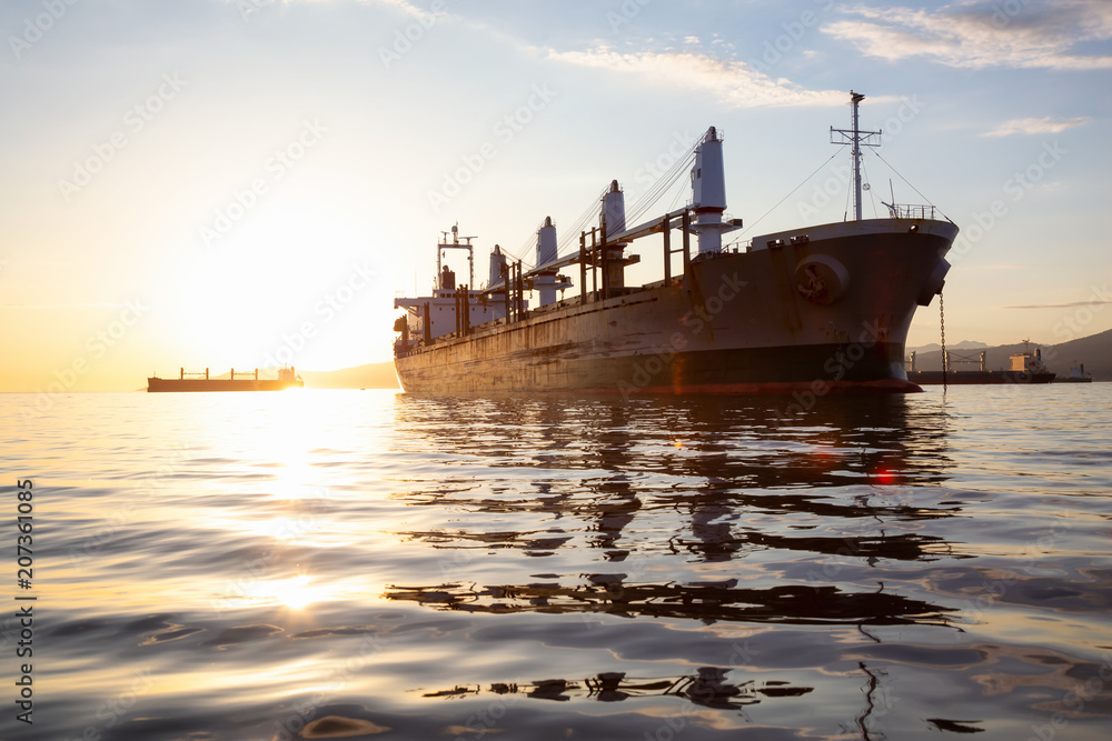 Old rusty ship is parked in the Port during a vibrant sunset. Taken in Vancouver, British Columbia, Canada. Old rusty ship is parked in the Port during a vibrant sunset. Taken in Vancouver, British Columbia, Canada.