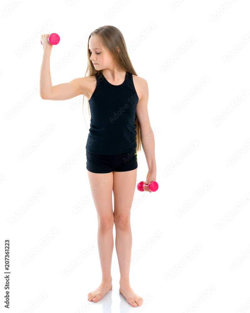 Teenage girl with dumbbells in hands Teenage girl with dumbbells in hands