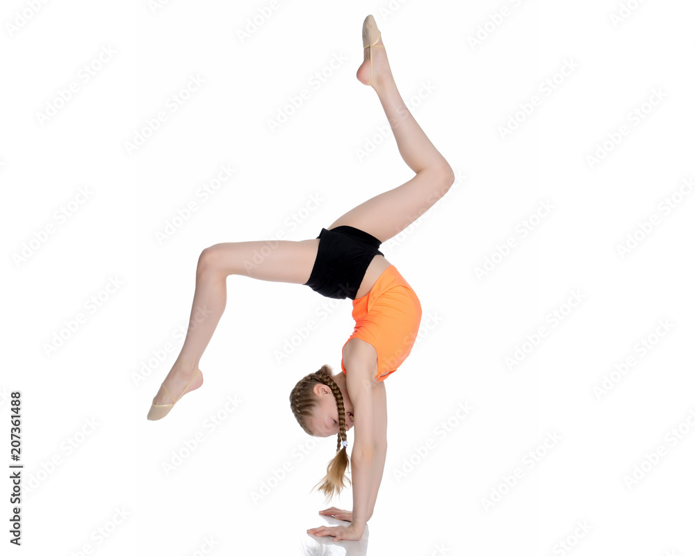The gymnast performs a handstand with bent legs. The gymnast performs a handstand with bent legs.