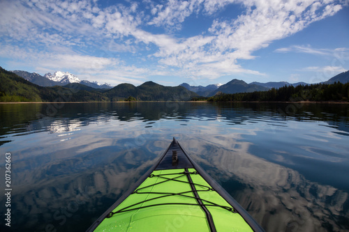 Kayaking during a beautiful morning surrounded by the Canadian Mountain Landscape. Taken in Stave Lake, East of Vancouver, British Columbia, Canada.