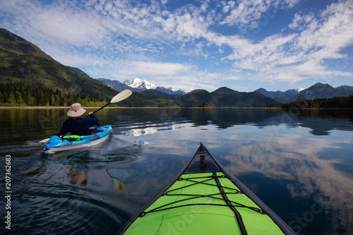 Kayaking during a vibrant morning surrounded by the Canadian Mountain Landscape. Taken in Stave Lake, East of Vancouver, British Columbia, Canada. Concept: Adventure, vacation, holiday