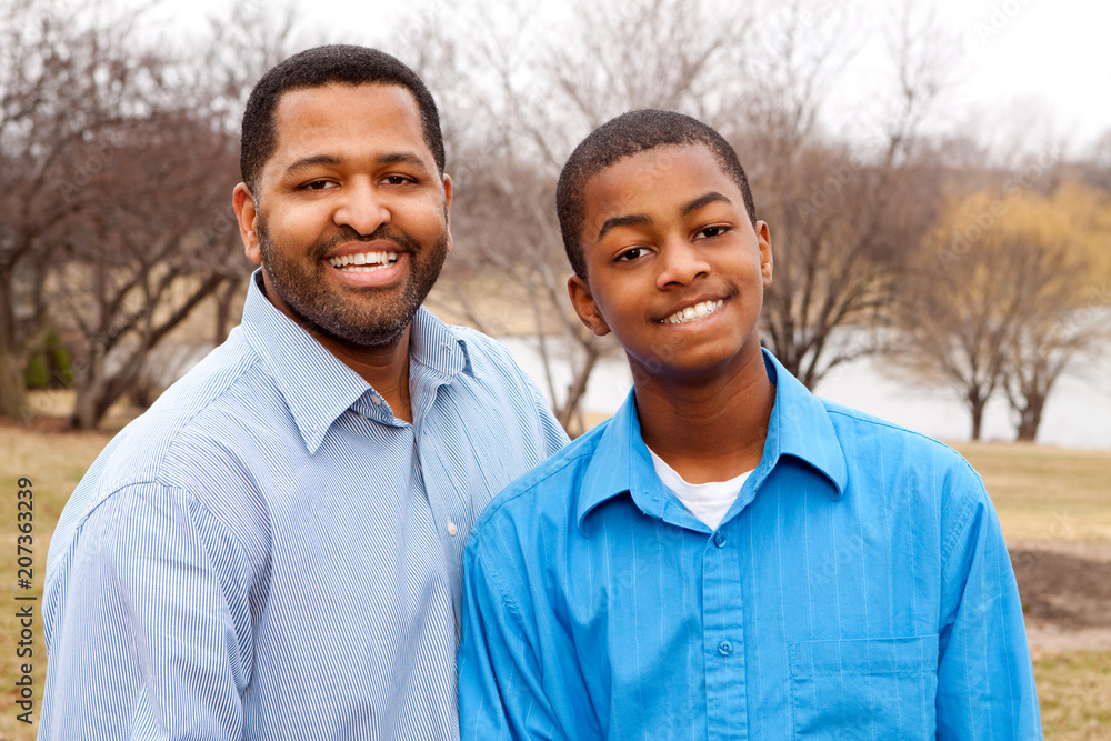 Happy African American father and son talking and laughing. Happy African American father and son talking and laughing.