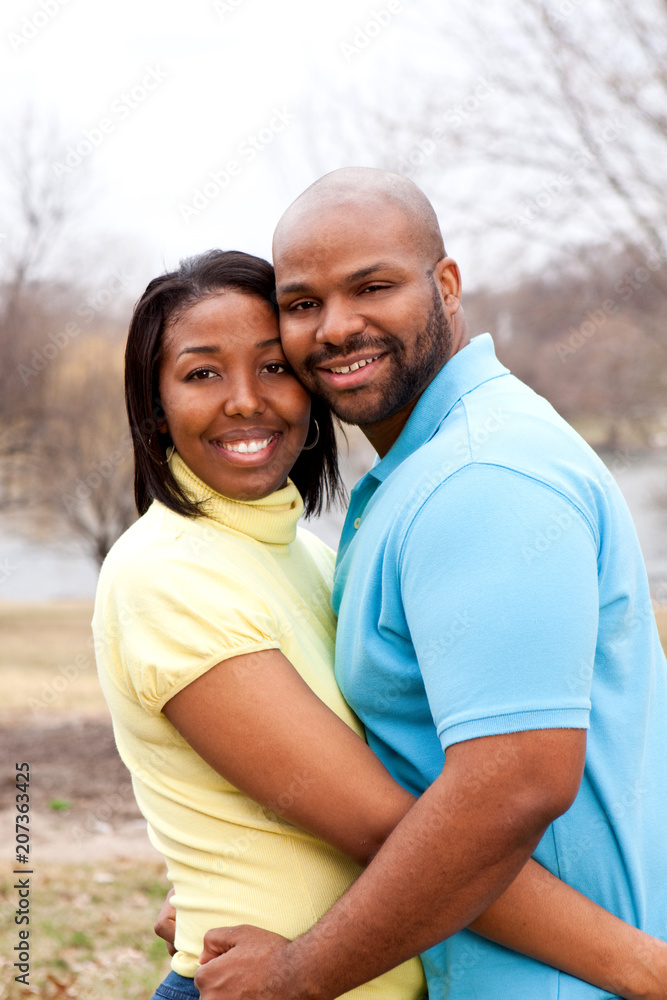 Fototapeta premium Happy African American couple hugging outside.
