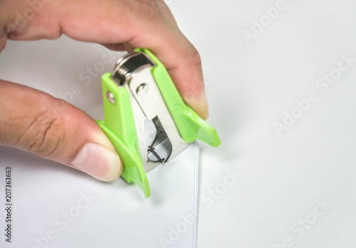 close up businessman remove staple from documents by puller