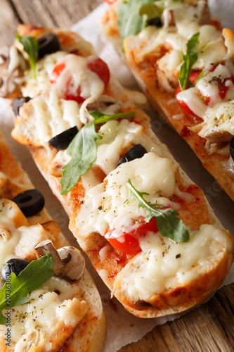 Hot sandwich casserole pizza with chicken, mozzarella cheese, tomatoes and mushrooms close-up. vertical