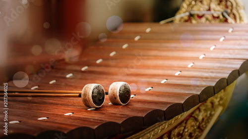 close up of alto xylophone traditional classical Thai and sountheast asia musical instrument made of wood making sound by hit sticks to wood rail photo