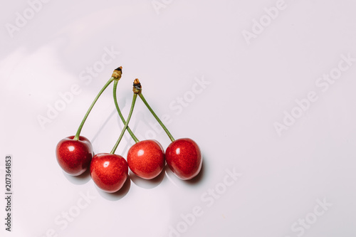 Fresh cherry on plate on wooden blue background. fresh ripe cherries. sweet cherries. photo