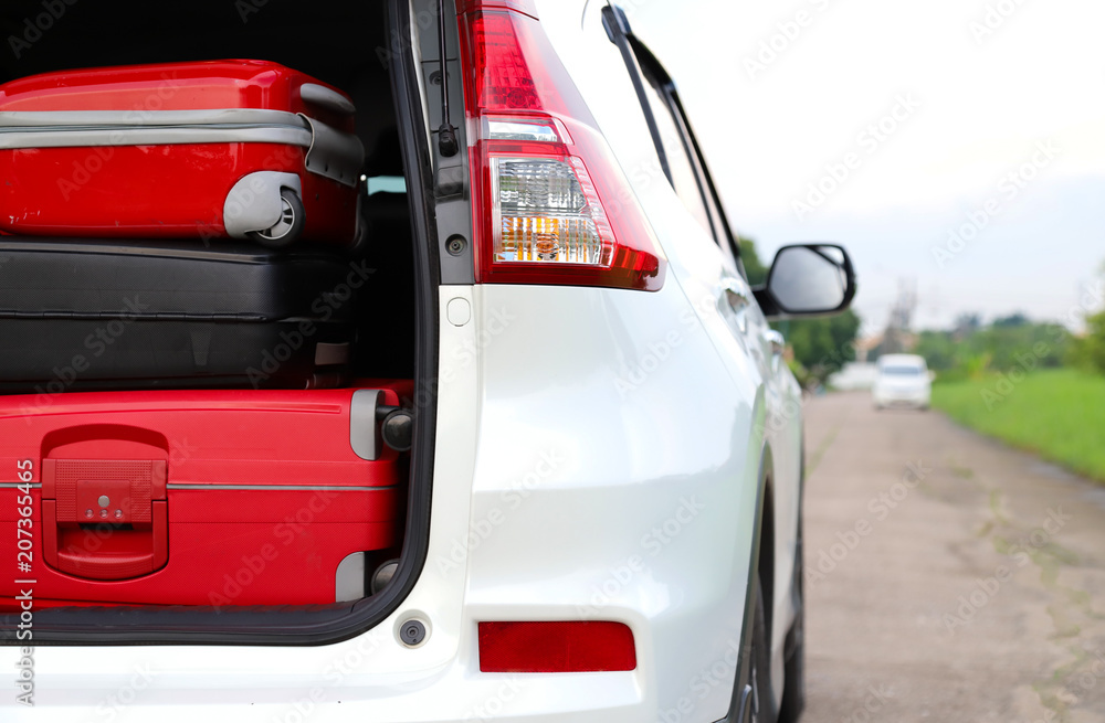 Closeup of right rear side of white car carry suitcases for lovely family holiday in summer.