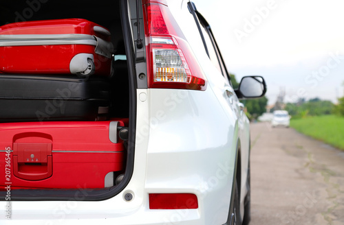 Closeup of right rear side of white car carry suitcases for lovely family holiday in summer. © Amphon