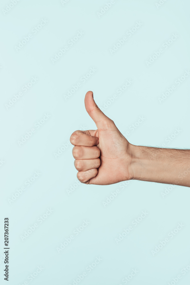 cropped image of man doing thumb up gesture isolated on blue background cropped image of man doing thumb up gesture isolated on blue background