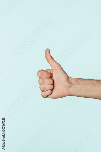 cropped image of man doing thumb up gesture isolated on blue background