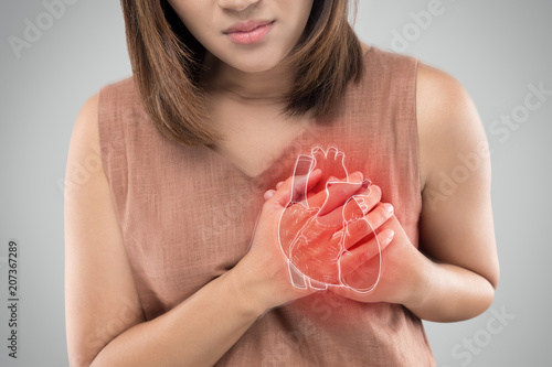 Canvas Print The photo of heart is on the woman's body, Severe heartache, Having heart attack or Painful cramps, Heart disease, Pressing on chest with painful expression
