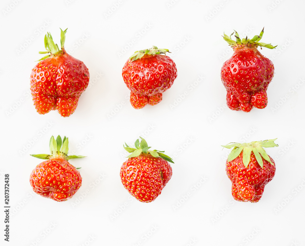 Top view. Set of strawberries isolated on white background. Strawberries of non-standard shape on a on white background. Ripe strawberries close-up. Top view. Set of strawberries isolated on white background. Strawberries of non-standard shape on a on white background. Ripe strawberries close-up.