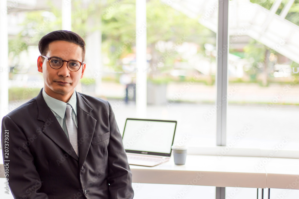 Asia business man working with laptop while sitting coffee shop .Concept of young business people Asia business man working with laptop while sitting coffee shop .Concept of young business people