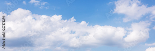 panorama mit vielen weißen wolken vor blauem himmel