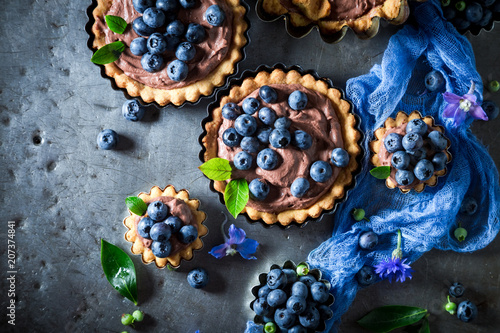 Sweet and tasty tarts with brown cream and fresh berries
