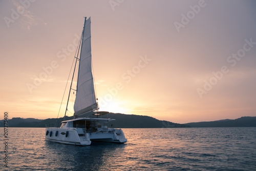 Konstfotografi Yacht - Catamaran in the ocean. Sailing at sunset