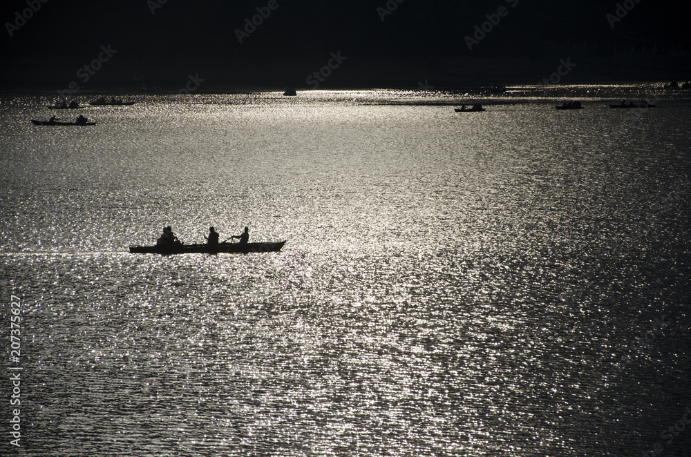 A vacationer enjoying a boat ride in nainital lake during a summer evening