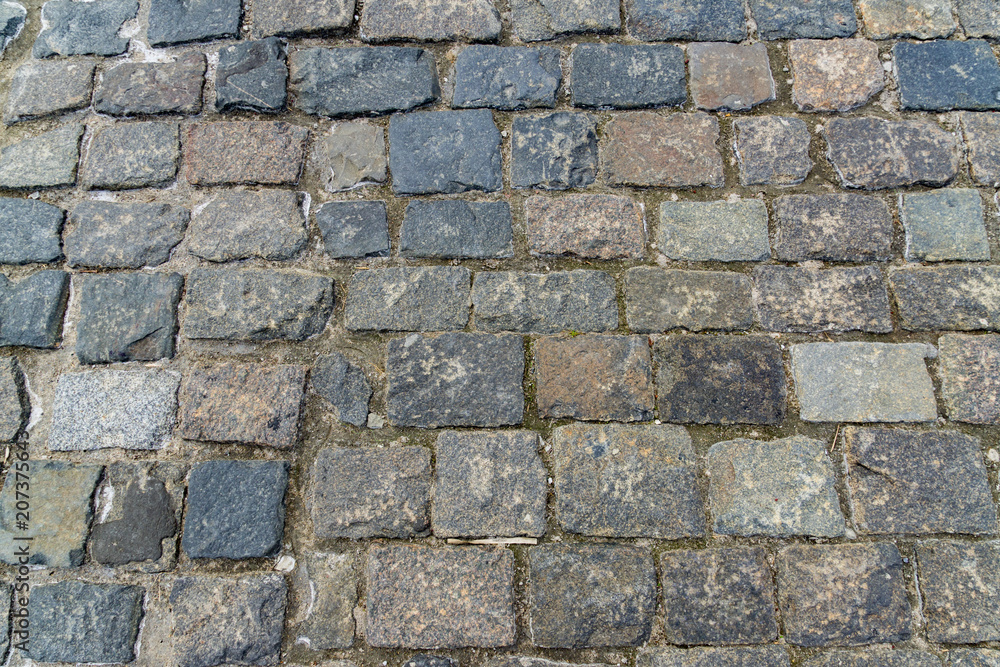 granite stone pavement texture. Abstract background of old cobble stone pavement closeup. granite stone pavement texture. Abstract background of old cobble stone pavement closeup.