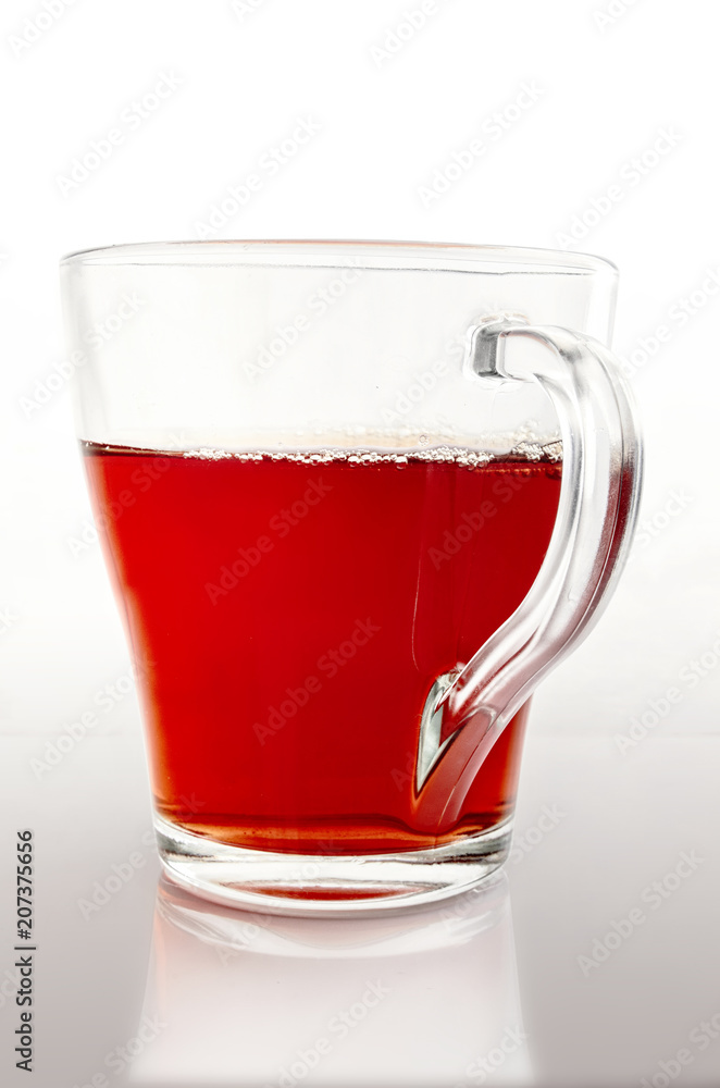 Glass cup of tea on a gradient light gray background vertically. Glass cup of tea on a gradient light gray background vertically.