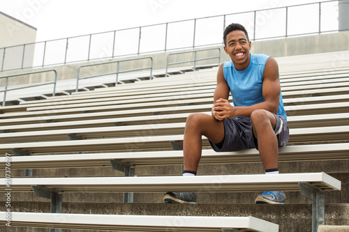 Teenage athlete sitting on the bleachers. © digitalskillet1