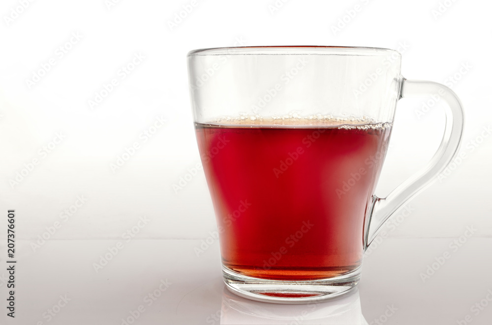 Glass cup of tea on a gradient light gray background. Glass cup of tea on a gradient light gray background.