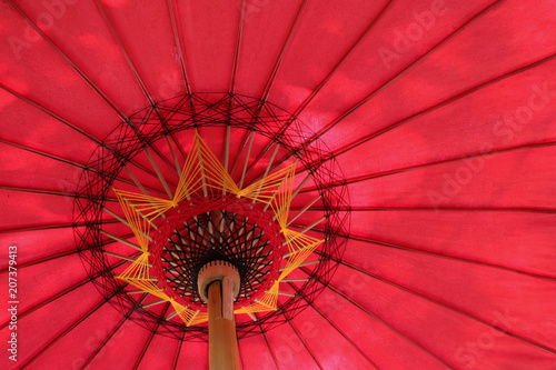 Closeup of under side of red handmade umbrella.