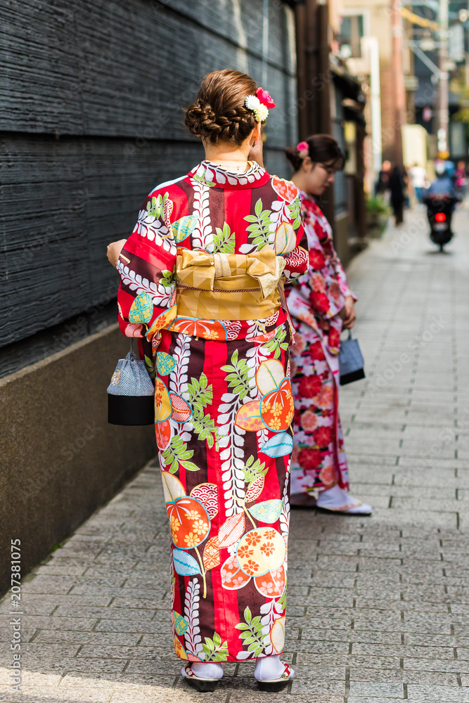 KYOTO, JAPAN - NOVEMBER 7, 2017: Girls in a kimono on a city street. Vertical. Copy space for text.