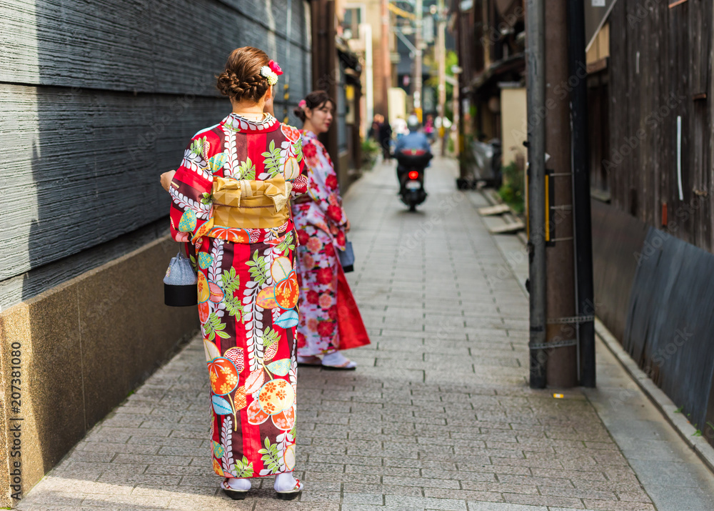 KYOTO, JAPAN - NOVEMBER 7, 2017: Girls in a kimono on a city street. Copy space for text.